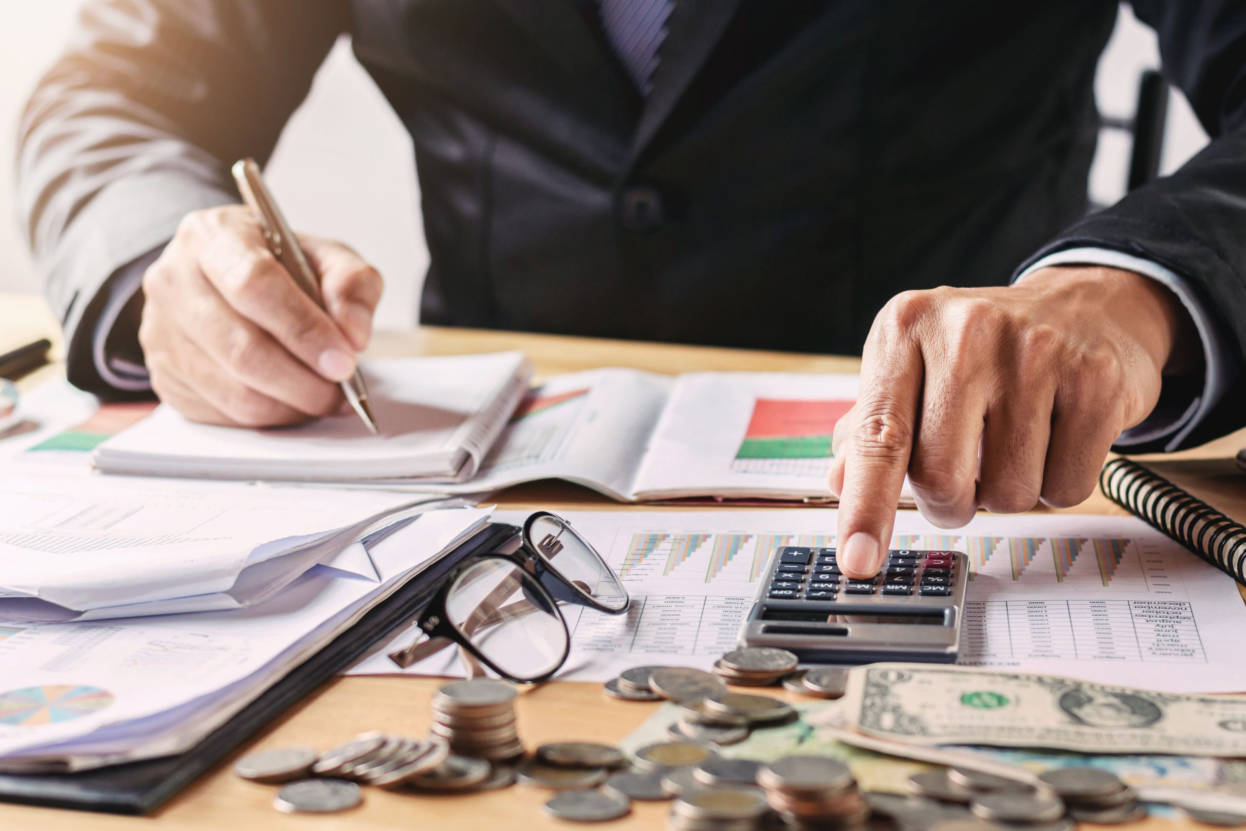 businessman-working-in-office-using-calculator-for-calculate-budget-money
