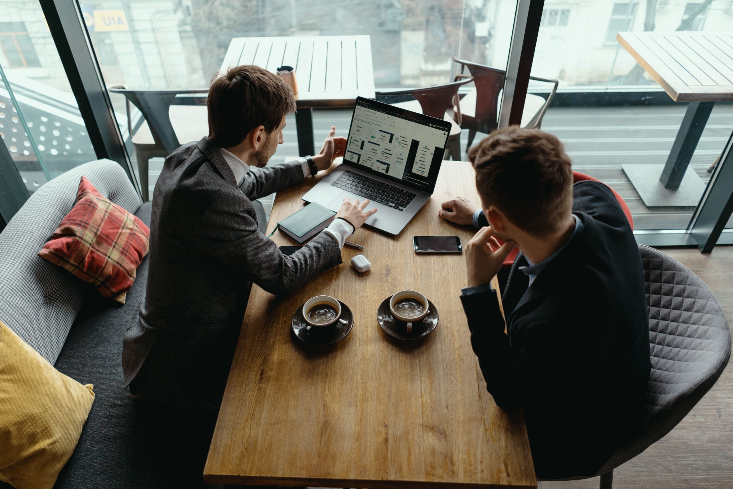 two-young-businessman-having-a-successful-meeting-at-restaurant